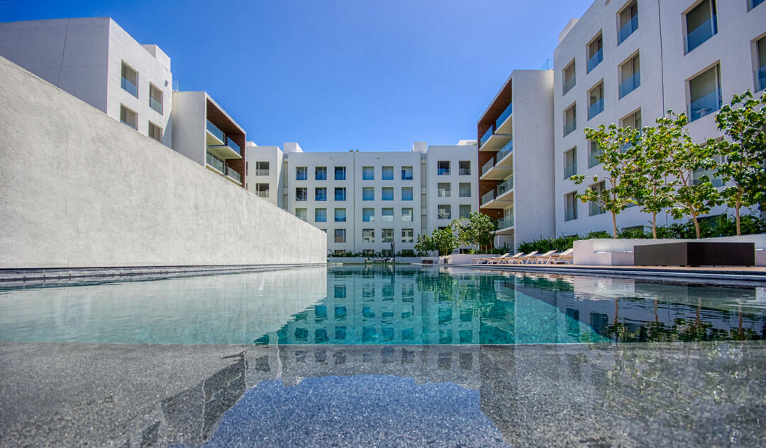 Los Cabos Marea Los Cabos Located in the exclusive Marea development, this 1,480 sq. ft. condo offers the premier downtown Cabo San Lucas lifestyle just 500 meters from Medano Beach. The contemporary, open-concept design features three spacious bedrooms--each with its own private balcony--and floor-to-ceiling windows that flood the sleek, white-cabinetry kitchen and living areas with natural light. This turnkey property is a lucrative opportunity for investors, coming fully furnished, equipped, and ready for immediate rental income with no renovations required. Residents enjoy premium community amenities, including 24/7 security, a lobby, a gym, and a sparkling pool. The standout rooftop terrace, with a jacuzzi , provides the perfect vantage point to take in the city for sale